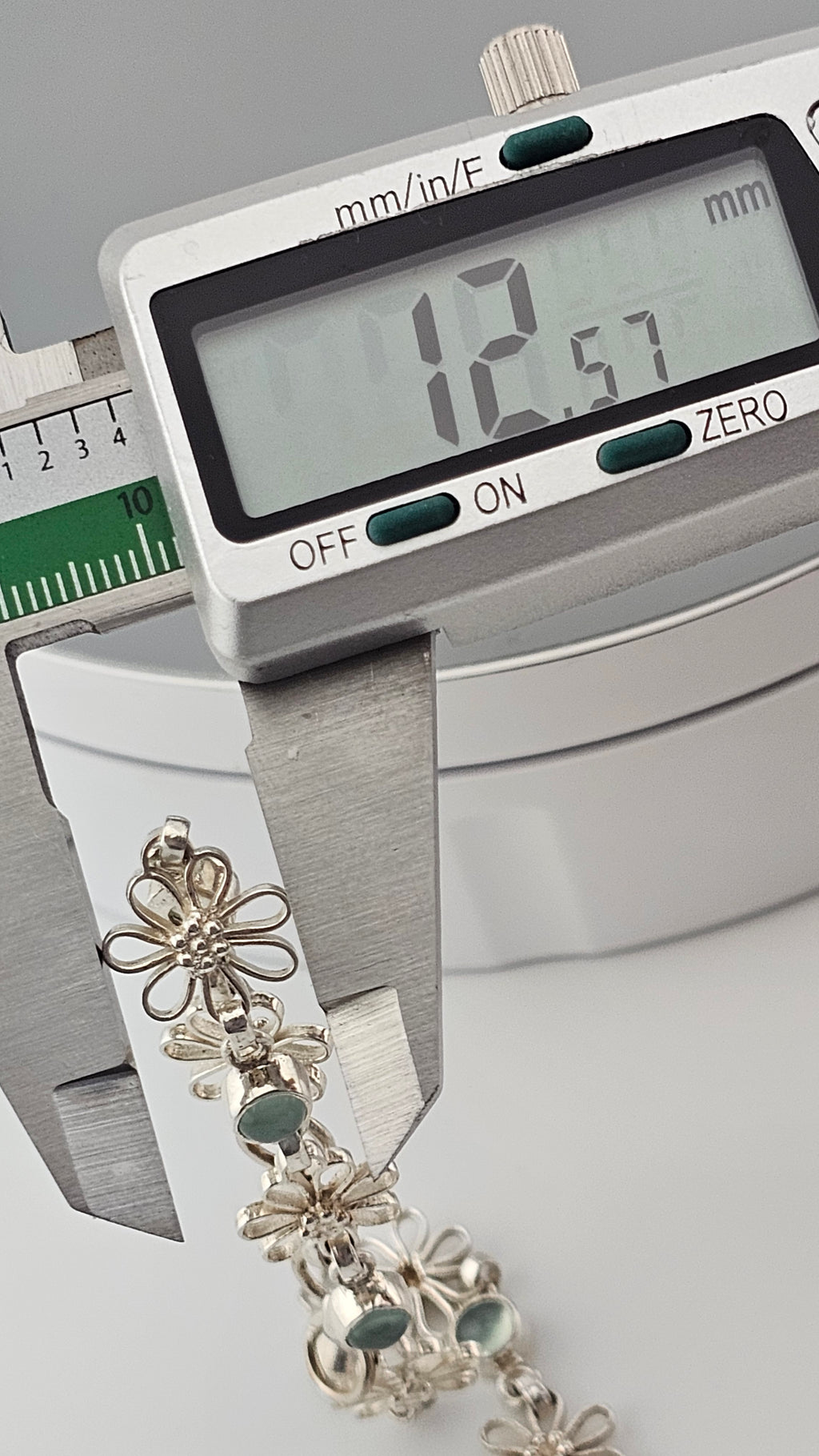 925 sterling silver daisy link bracelet featuring light blue, round cabochon aquamarine